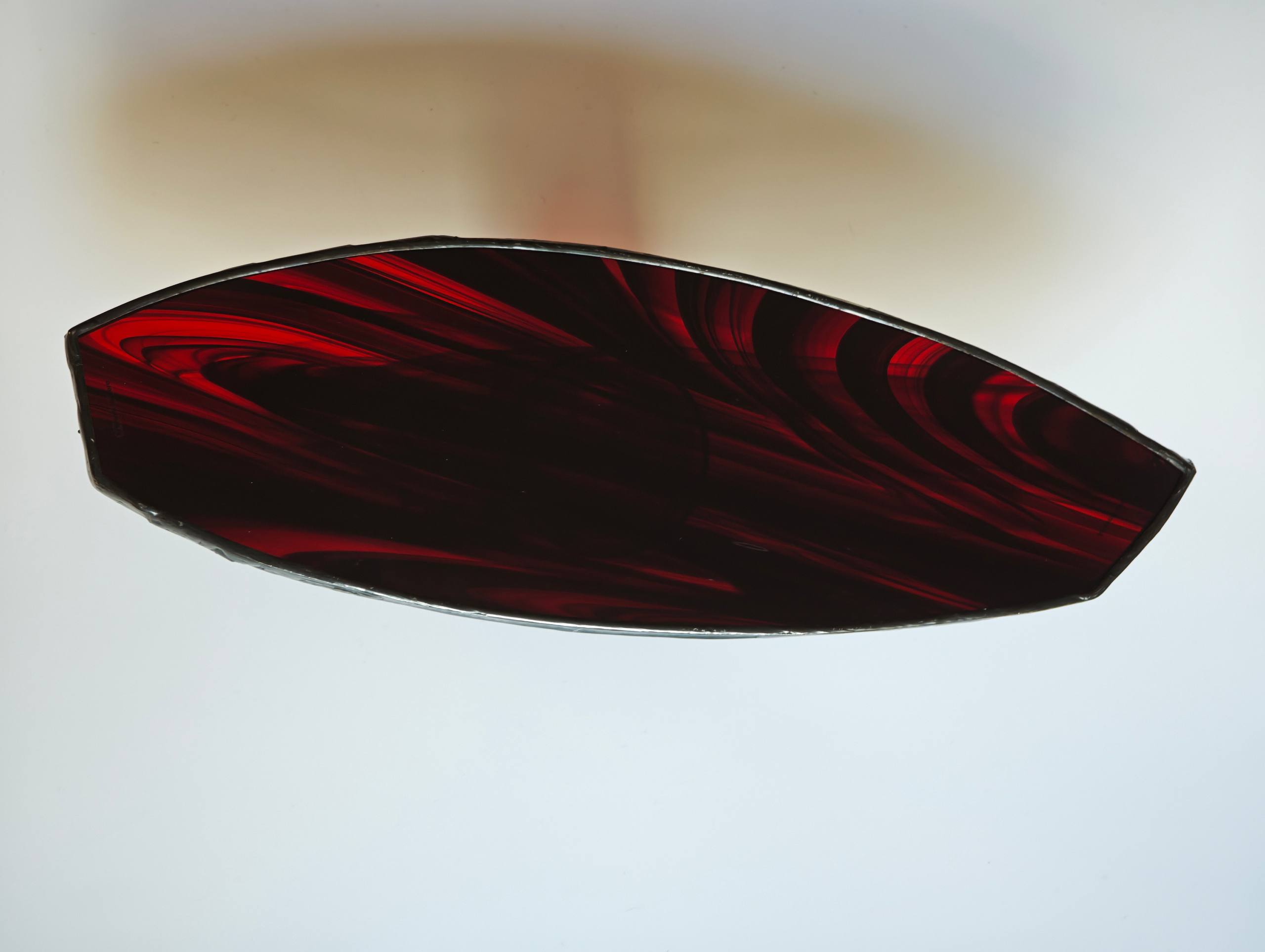 Dark red glass leaf form