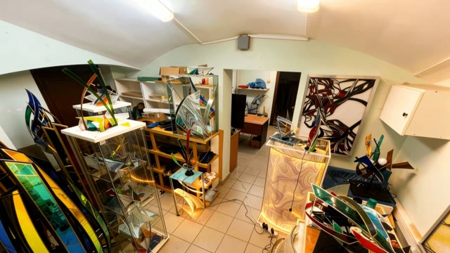 Wide view of the studio with sculptures and stained glass works